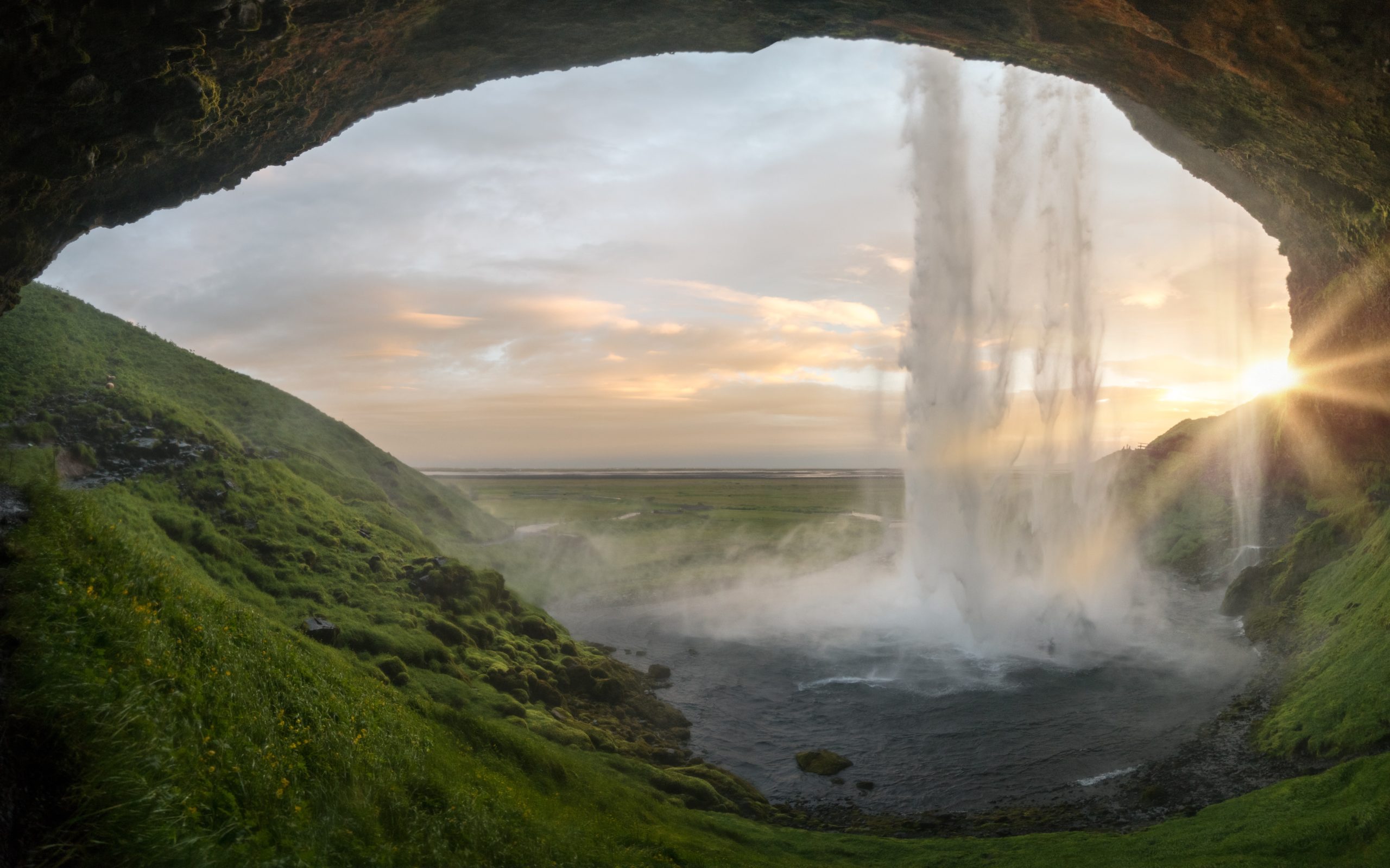 A waterfall from inside a cave