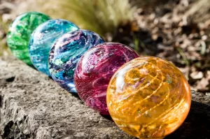 colored glass orbs for cremation ashes in a garden